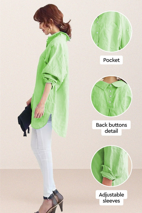 Oversized linen shirt in light green with back button detail, adjustable sleeves, and relaxed fit model wearing white pants and heels