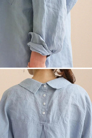 Light blue oversized linen shirt with rolled sleeves and buttoned back detail