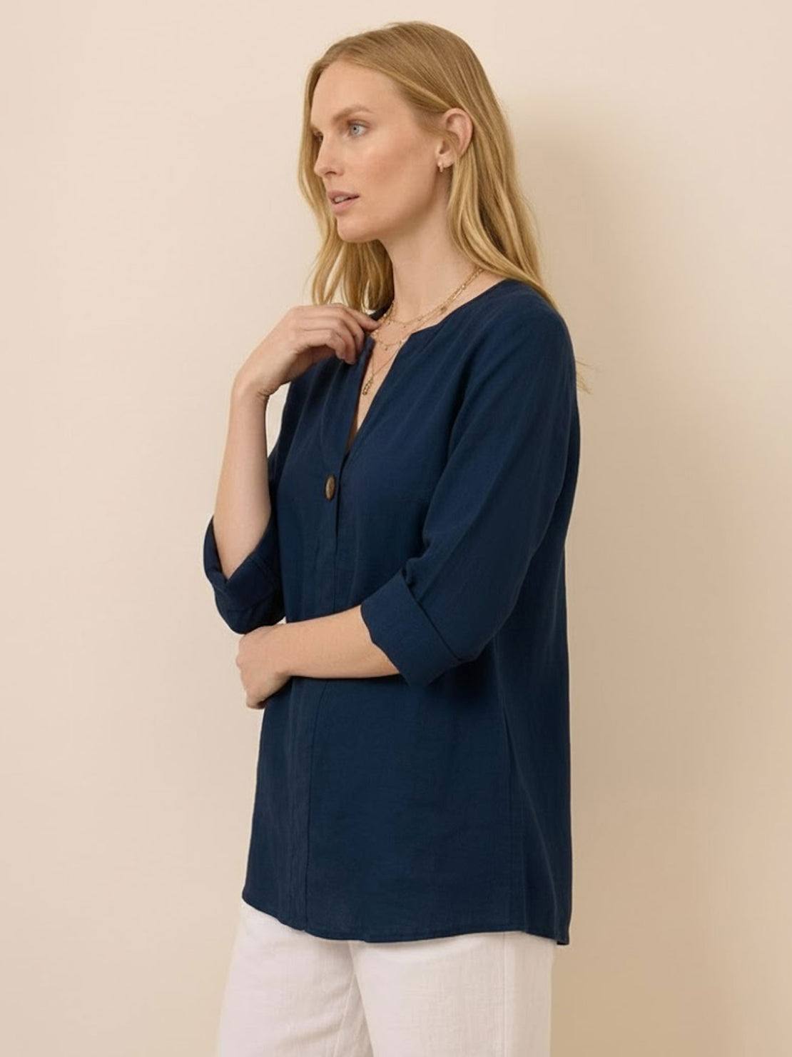 white pure linen age-defying shirt with button detail on wooden hanger