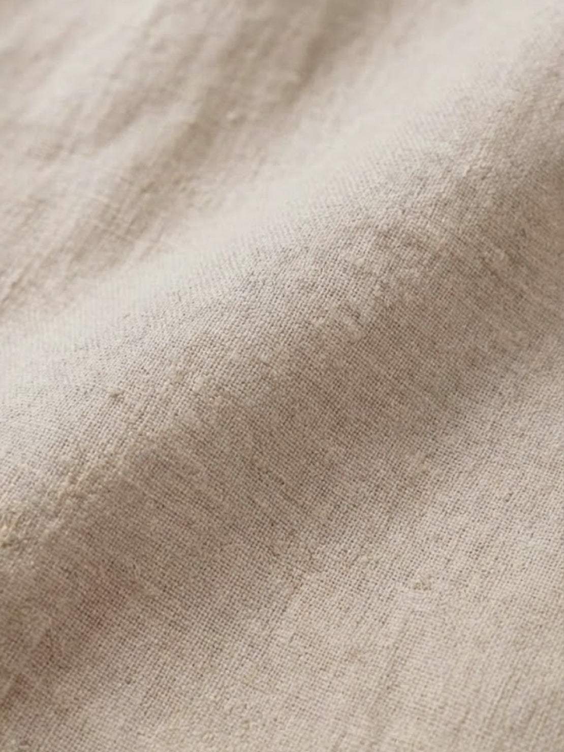 woman wearing pure linen age-defying button detail shirt in soft white fabric