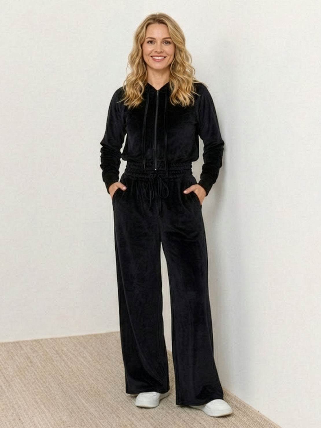 Woman wearing modern cropped velour tracksuit with high-waist pants in vibrant color