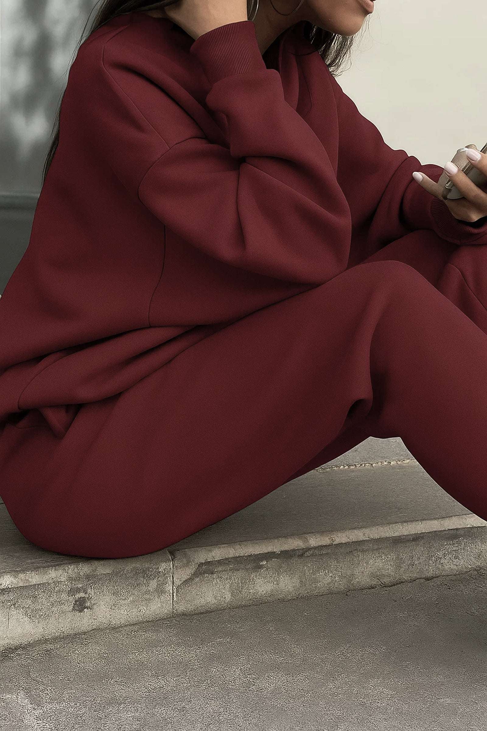 Burgundy cotton blend tracksuit with relaxed fit and minimal design, featuring stretch waistband and cuffs for tailored comfort.