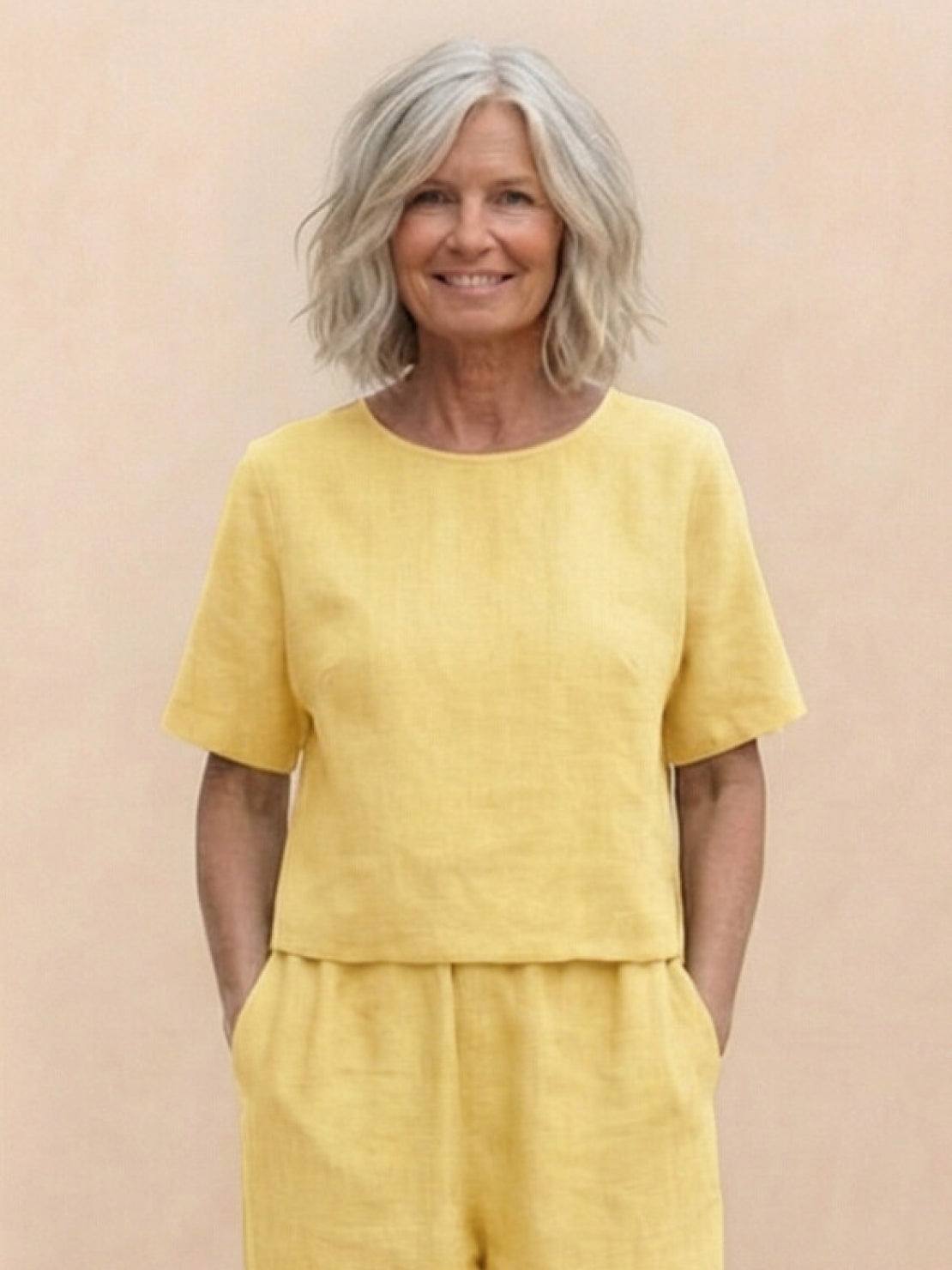 Woman wearing a loose fit co-ord set with a soft-tailored top and wide-leg bottoms in a relaxed, breathable fabric.