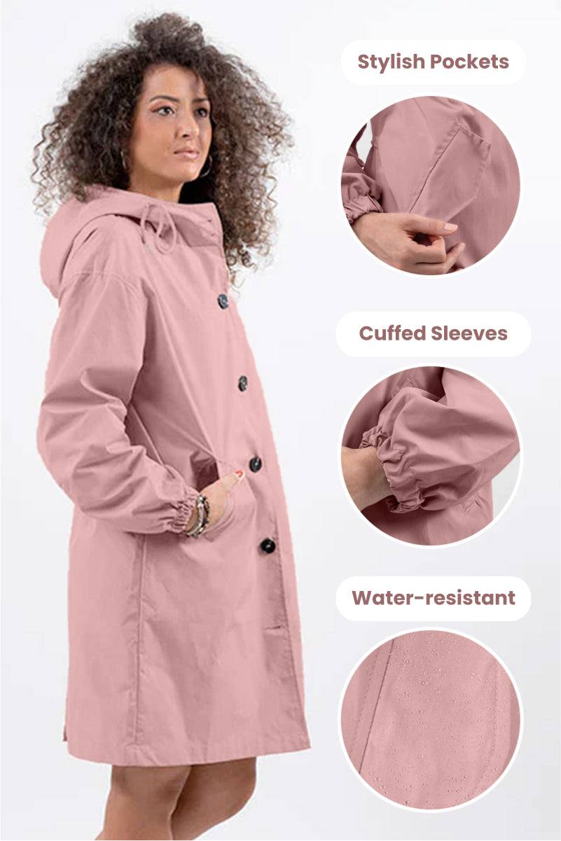 Woman wearing pink oversized Rain Couture Windbreaker with hood, stylish pockets, cuffed sleeves, and water-resistant fabric.