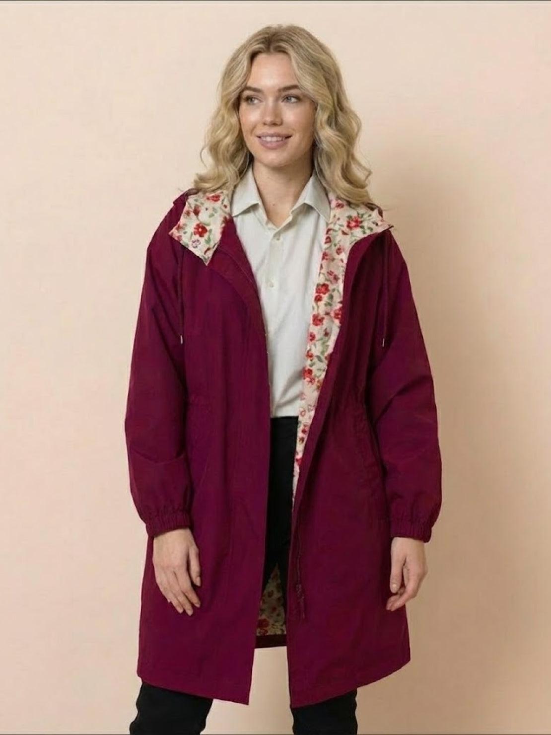woman wearing burgundy Rain Couture Windbreaker with floral inner lining and adjustable hood