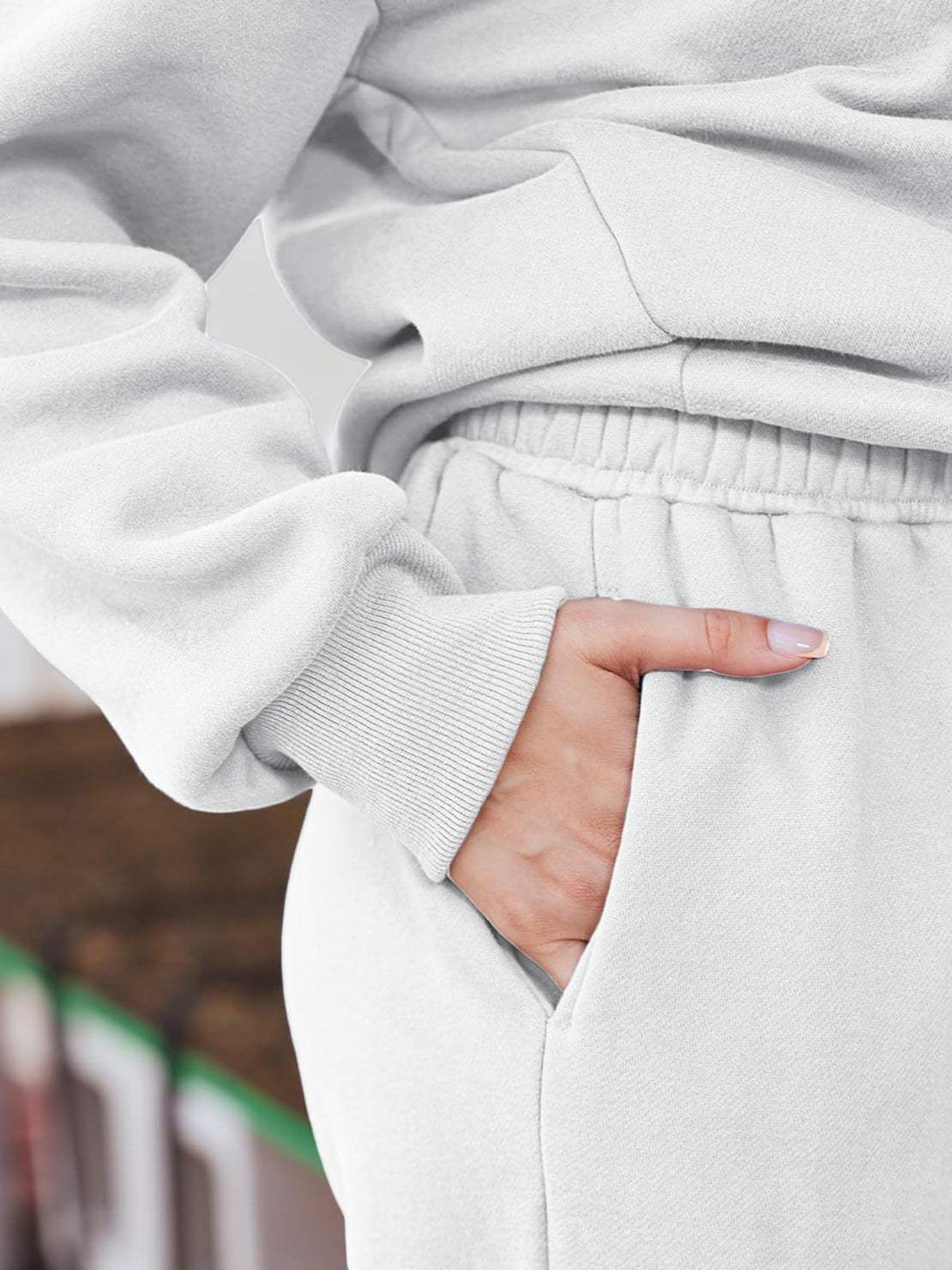 Close-up of white ultra-soft and comfy co-ord tracksuit set showing elastic waistband and hand in pocket