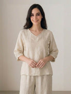 100% cotton linen blend coordinated set with embroidered V-neck top and high-waisted wide-leg trousers