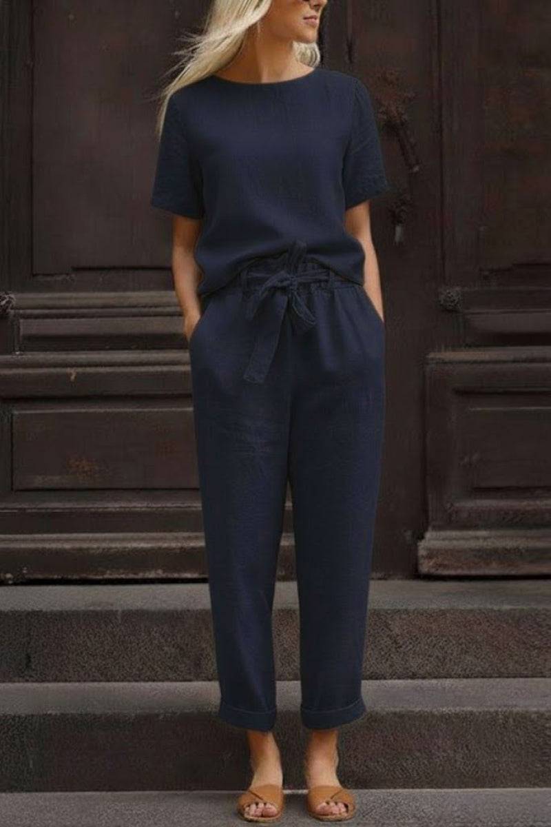Woman wearing navy blue relaxed cotton linen set with short-sleeve top and drawstring pants