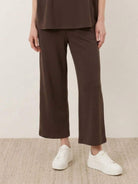Woman wearing cotton-blend capelet lounge set with mock neck top and wide-leg pants in chocolate brown