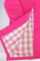 Barbara Pink Raincoat showing bright pink exterior with checkered interior lining