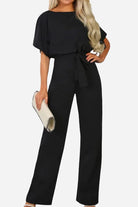 Chic short-sleeved black wide-leg jumpsuit with belt and elegant fit for women