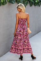 woman wearing vintage flower prints maxi dress with spaghetti straps and elastic waist walking outdoors
