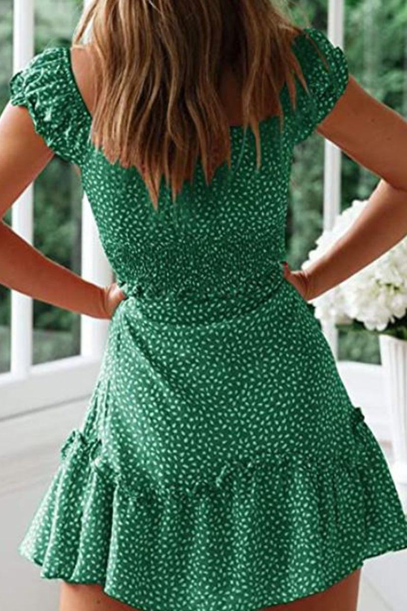 Woman wearing green sweetheart collar printed ruffled maxi dress with high waist and ruffle sleeves.