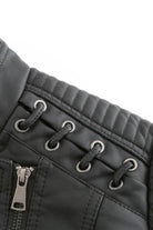 Close-up of slim fit leather motorcycle jacket with quilted shoulder and zipper details