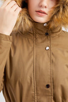 Close-up of large hooded velvet coat with fur-trimmed hood in brown color
