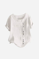 White relaxed fit linen button-up tee with short sleeves and button accent