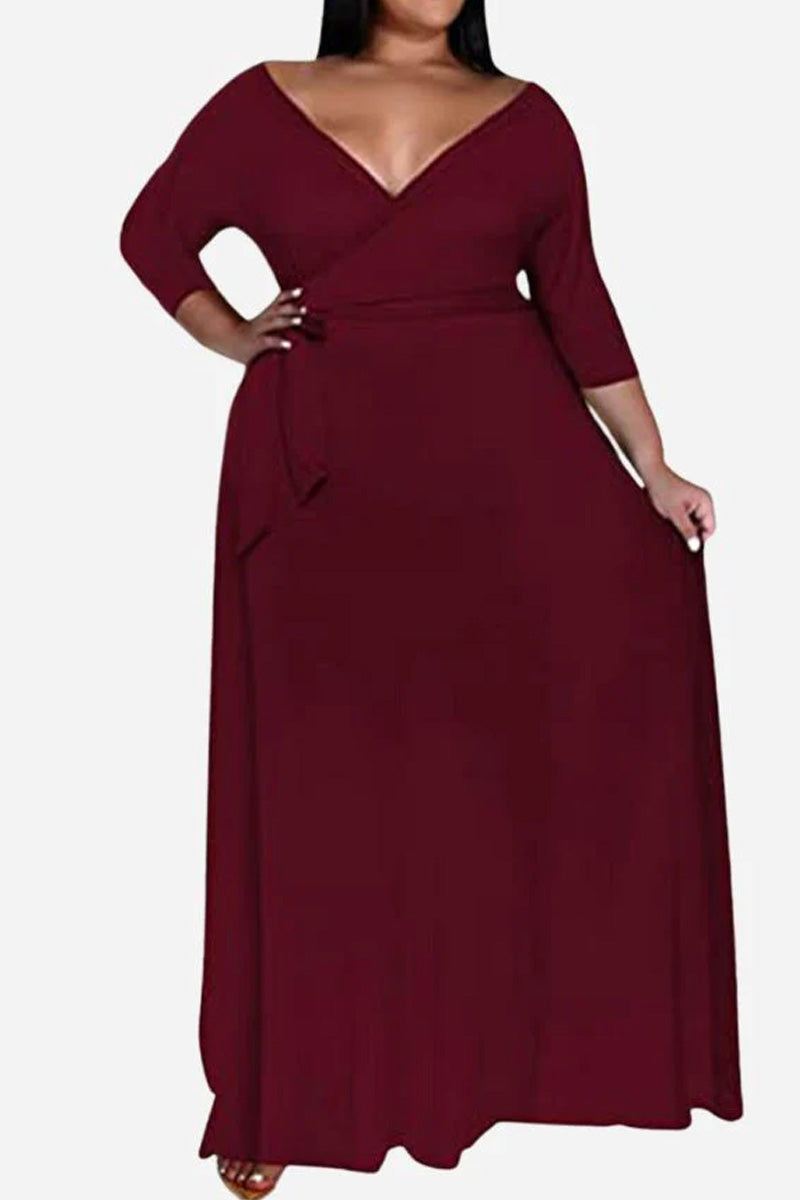 Elegant plus size dress with deep V-neck, 3/4 sleeves, belted waist, and swing skirt in solid burgundy color.