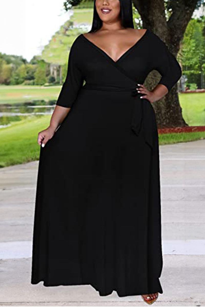 Plus size black belted dress with deep V-neck and 3/4 sleeves, swing skirt design.