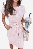 Woman wearing Airy Stripe Sheath Cotton Dress with tie waist and pockets holding Starbucks cup and checkered handbag