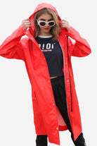 Lightweight ultra water-resistant red long windbreaker jacket with hood worn by woman