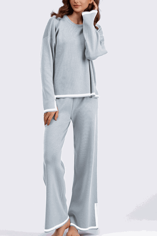 Long sleeved relaxed fit lounge two-piece set in light blue with white trim, featuring a loose sweater and wide-leg palazzo pants.