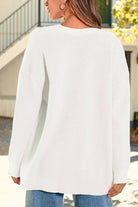 Relaxed fit oversized white knit cardigan on woman outdoors back view
