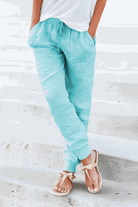 Light blue relaxed chic elastic ankles pants with drawstring waist and tapered cuffs, styled with casual sandals