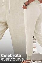Beige relaxed chic elastic ankles pants with a comfortable fit and tapered cuffs.