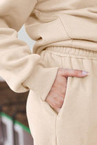 Close-up of beige ultra-soft and comfy co-ord tracksuit set with elastic waistband and side pocket detail