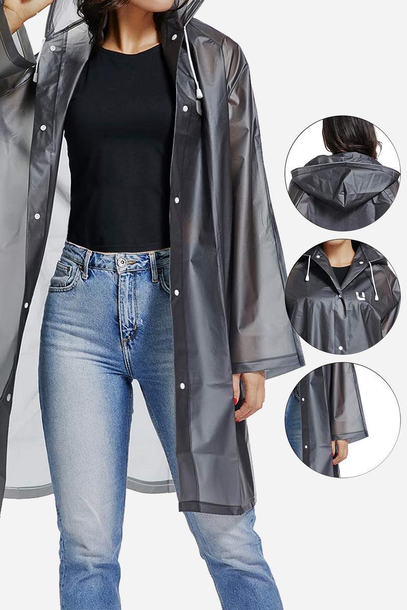 Chic Drizzle Defender black transparent raincoat with hood and snap buttons on model wearing jeans and black shirt