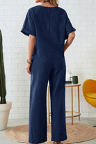 Woman wearing navy rolled cuff top and patch pocket pants set, relaxed fit, casual loungewear outfit