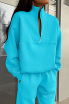 Women's cotton-blended two-piece tracksuit in bright blue with high collar and deep zipper, casual and comfortable athleisure wear.