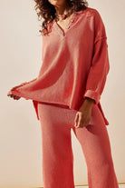 woman wearing coral pink textured two-piece oversized set for multi-weather comfort