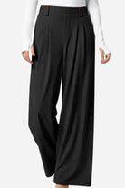 High-waisted plicated wide leg waffle pants in black with pleated design and wide-leg silhouette for a sleek, elegant look.