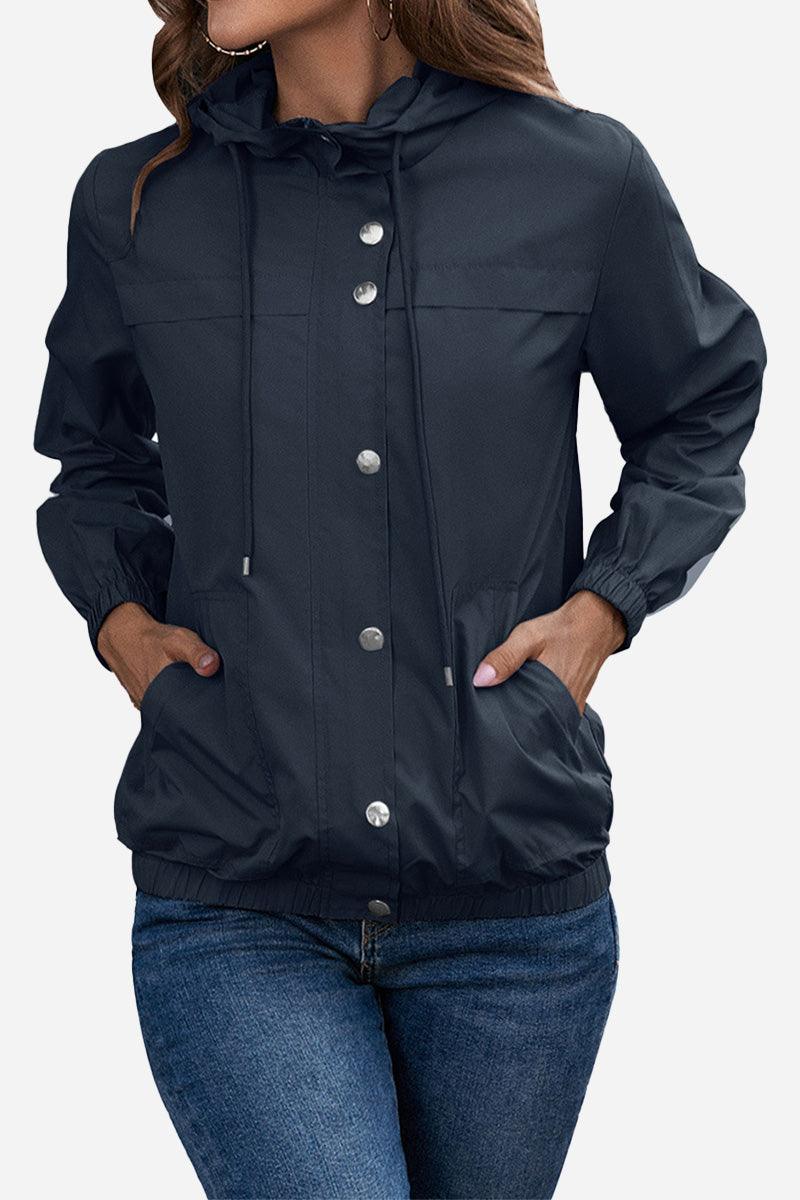 Women's navy blue outdoor hooded raincoat and windbreaker jacket with snap buttons and elastic cuffs.