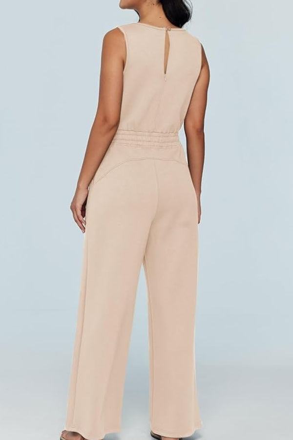 Back view of beige sleeveless wide leg pants jumpsuit with drawstring waist and keyhole back detail