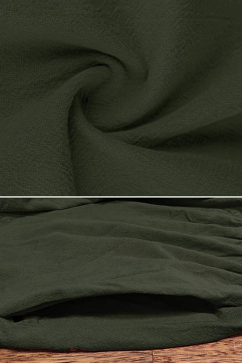 Close-up of dark green anti-shrink fabric texture and pocket detail of capped-sleeve voluminous pleated midi dress