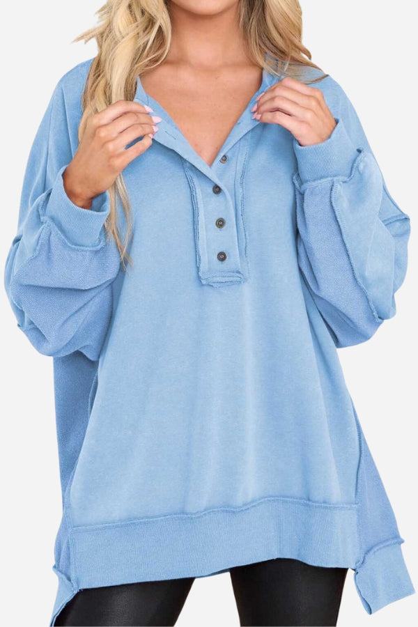 Light blue oversized urban sweatshirt with raw seam details and slouchy sleeves.