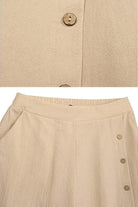 Beige wide leg pants with elastic narrow waist and side button detailing