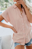 Women’s V-neck collared button blouse in soft pink with rolled short sleeves and relaxed fit