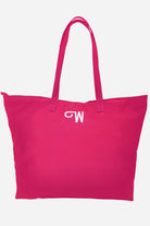 Red waterproof travel bag with long handles and embroidered logo, spacious and foldable design.