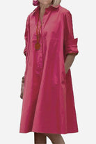 Pink long shirt-style dress with rolled sleeves and a relaxed fit