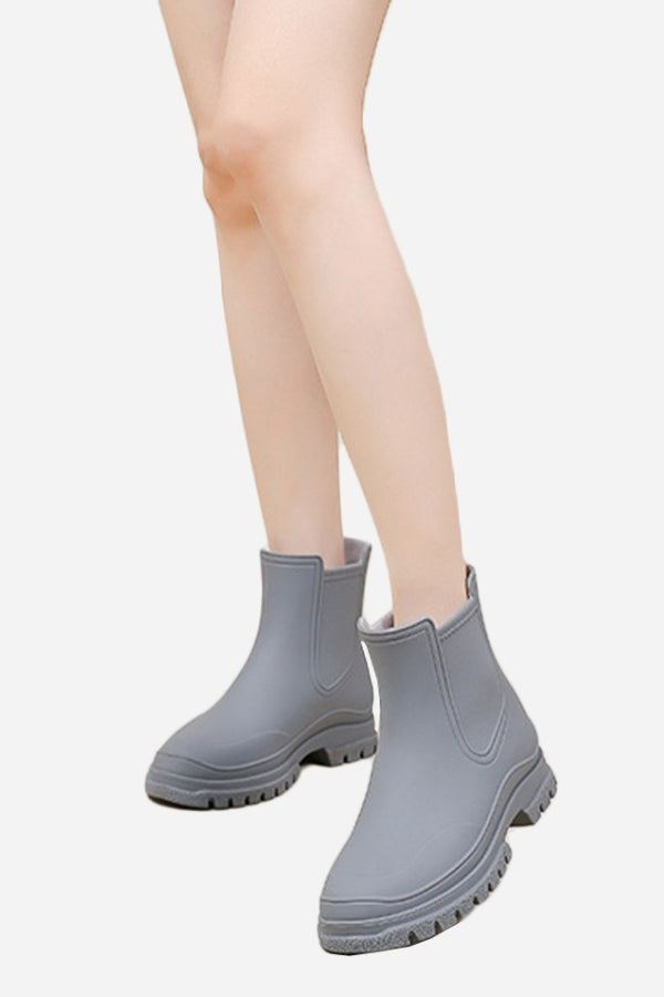 Gray non-slip rain boots with SuperGrip soles, waterproof and lightweight design for comfortable, confident walking in wet weather.