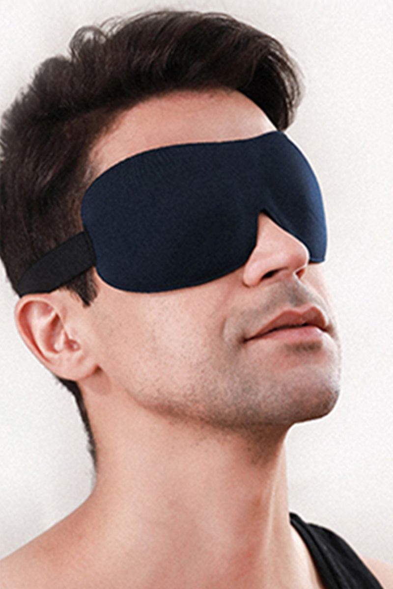 Man wearing blackout eye mask from Travel Comfy Kit for travel relaxation and comfort