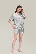 Woman wearing silver Mulberry silk buttoned short set nightwear