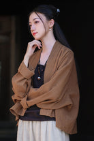 Woman wearing a brown ramie linen and cotton cardigan with relaxed fit and long sleeves