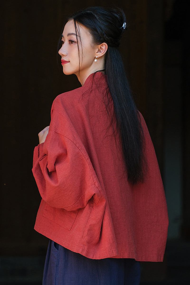 Woman wearing a deep red ramie linen and cotton cardigan with an open-front and relaxed fit