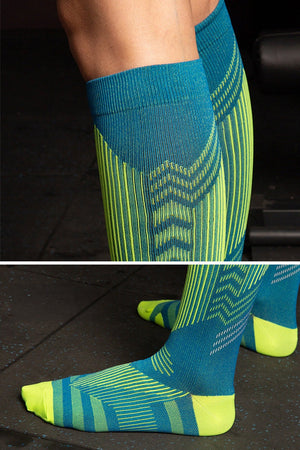 Premium compression socks in blue and green with gradual compression design for travel and leg fatigue relief