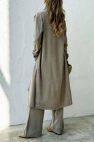 Woman wearing taupe one-size premium three-piece collection with cardigan and wide-leg pants seen from the back