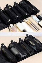 Compact black nylon travel makeup bag with multiple zippered compartments and organized cosmetic products inside for travel light look right